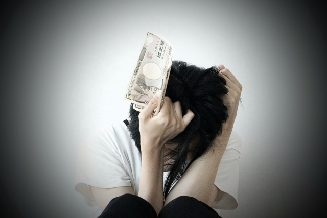 お金を手に頭を抱える。岸和田市で債務整理の無料相談が司法書士に可能